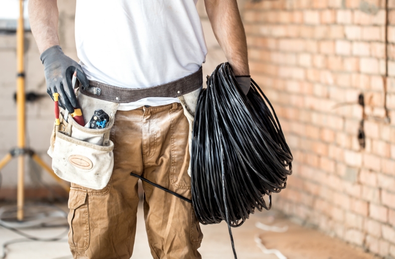 electrician with tools working construction site repair handyman concept